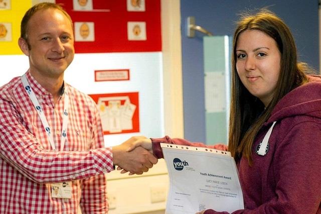 Image caption: Lucy is pictured here receiving her award from Mike Strang, Youth Scotland Chief Executive in a surprise in-person visit.
